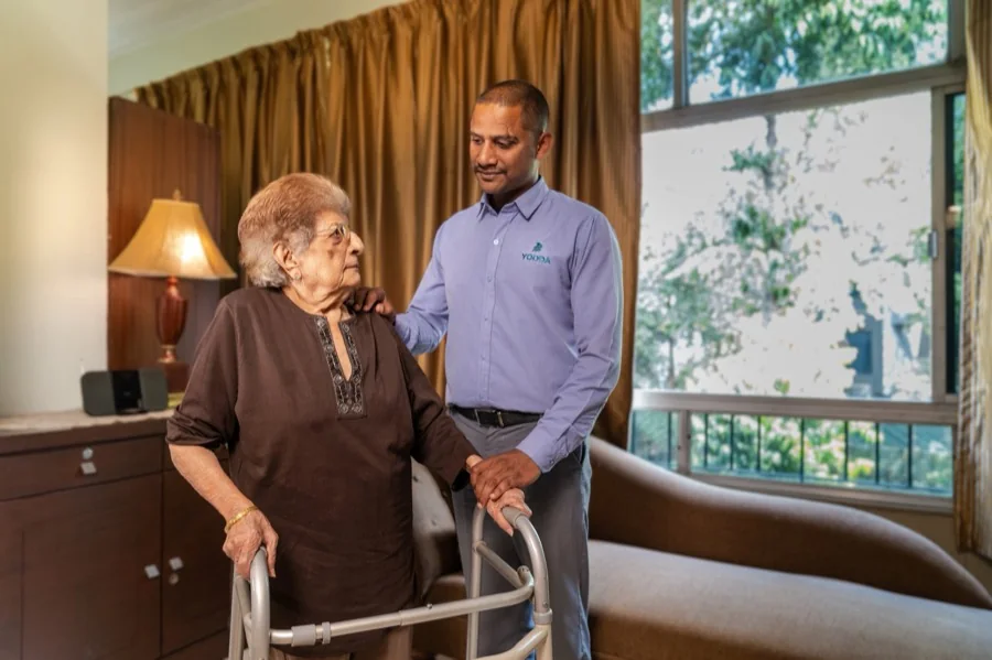 A Yodda team member speaking with an elder at home